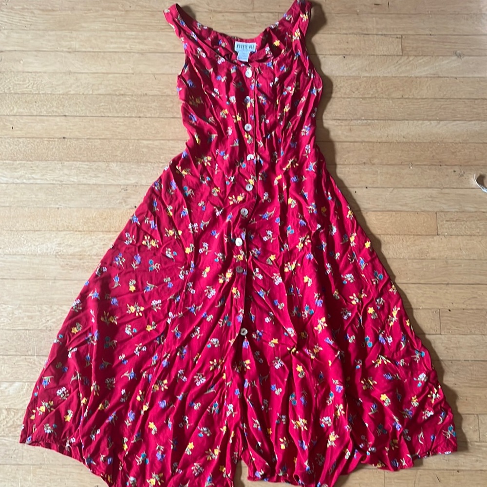 Floral red dress with tie in the back. Thick straps, roughly knee length skirt.